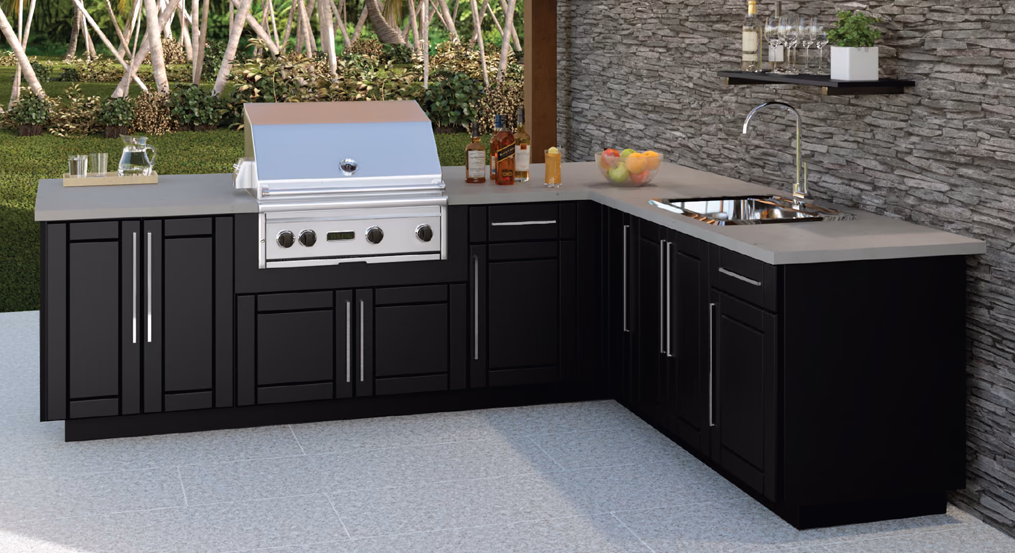 L-shaped outdoor kitchen with black Endura cabinets against a stacked stone wall