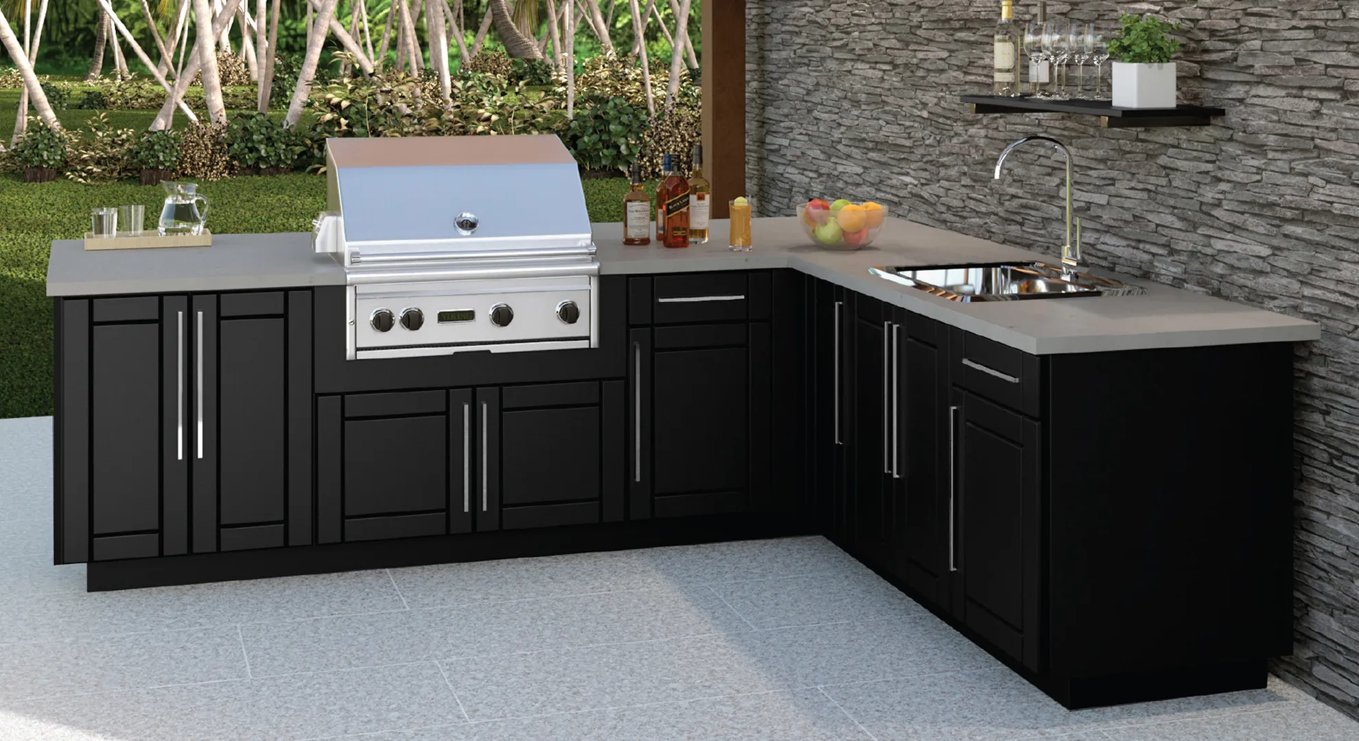 L-shaped outdoor kitchen with black Endura cabinets against a stacked stone wall