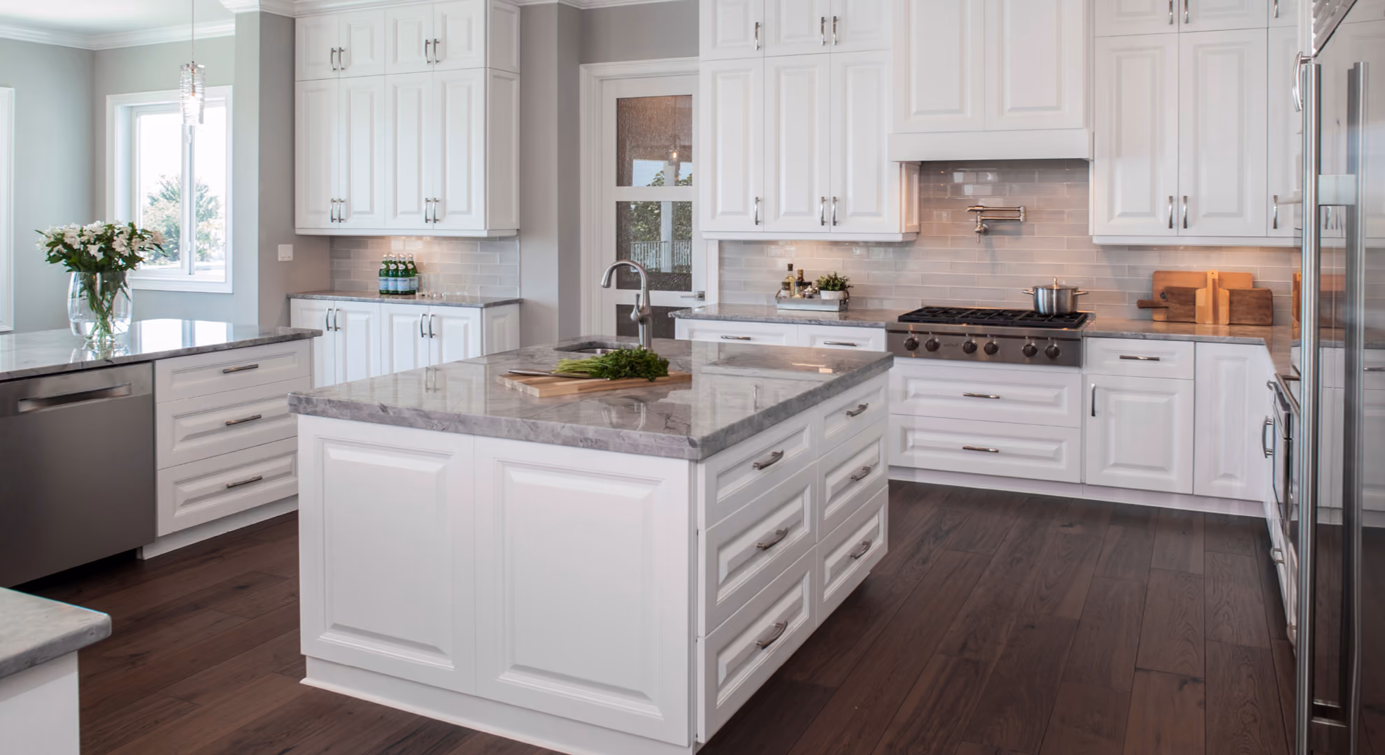 Classic White kitchen: white raised-panel with island and granite, wood floor