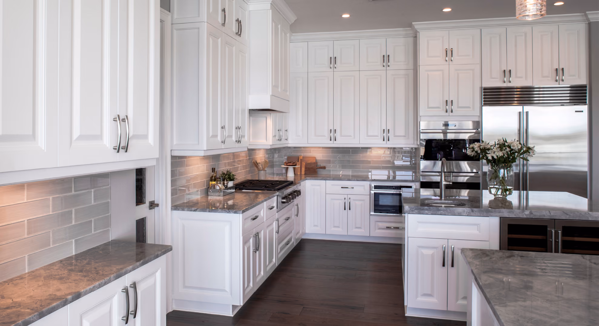 Kitchen: white raised-panel with gray tile backsplash, dark floor