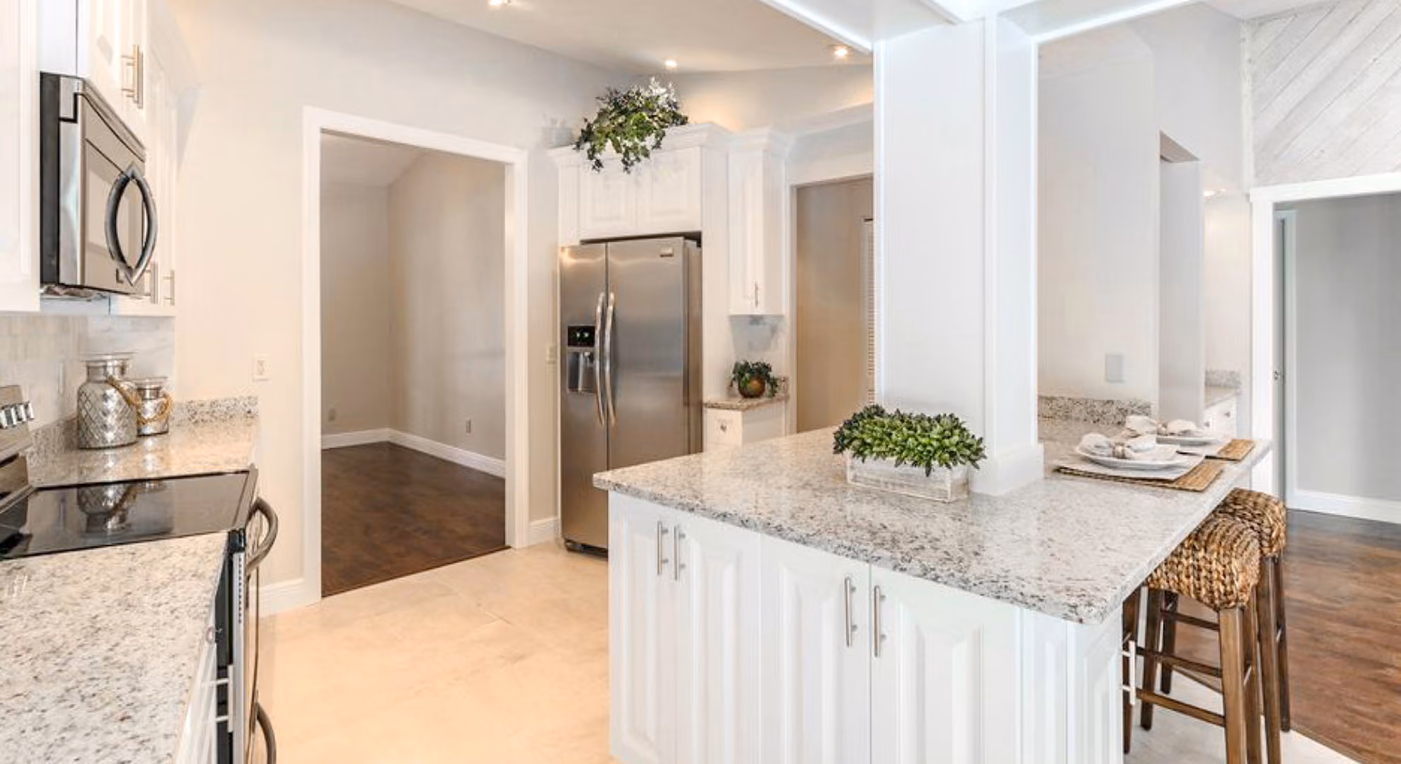 Kitchen: white raised-panel island with stool