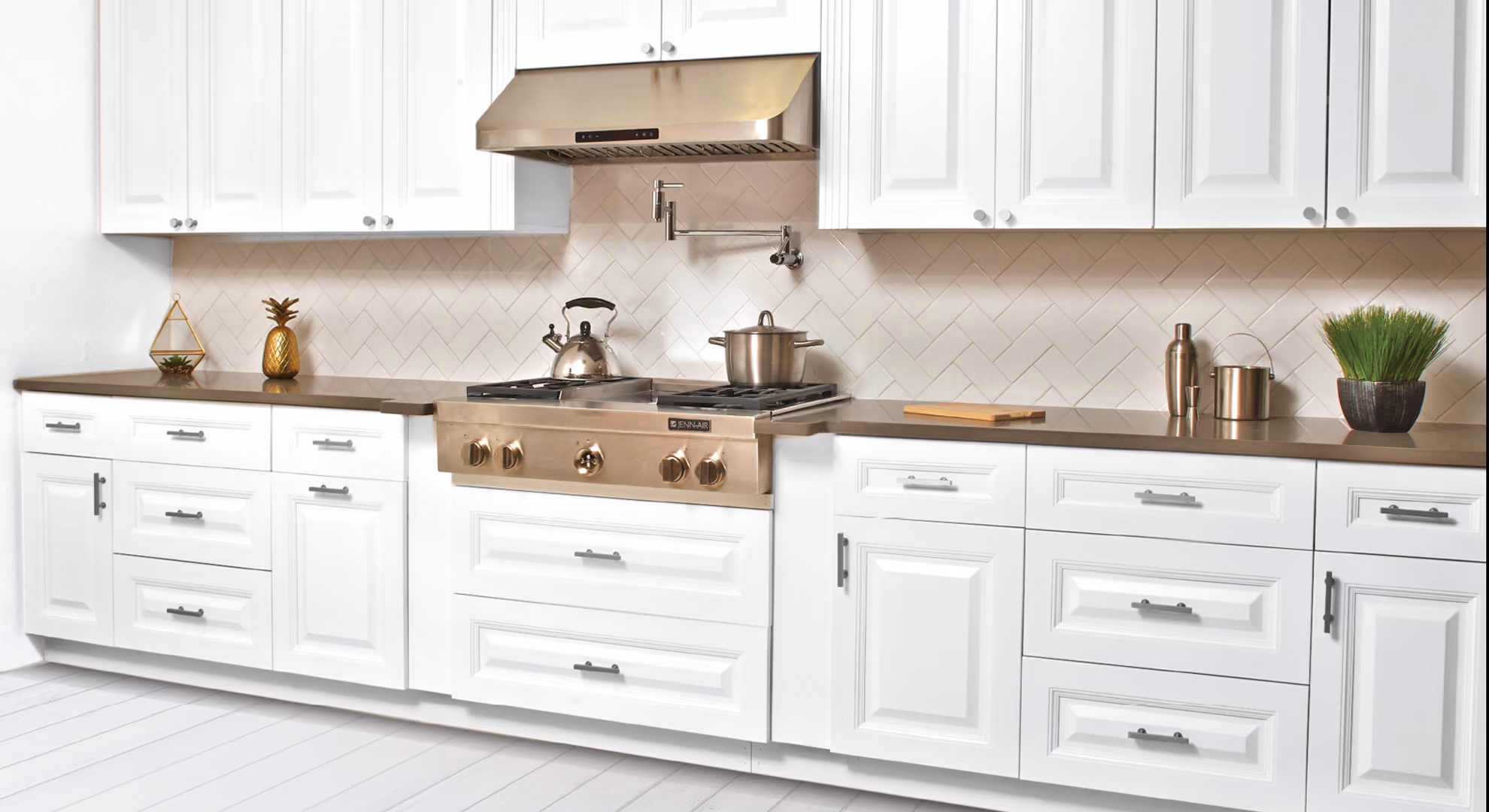 Kitchen range wall: white raised-panel, brass hardware