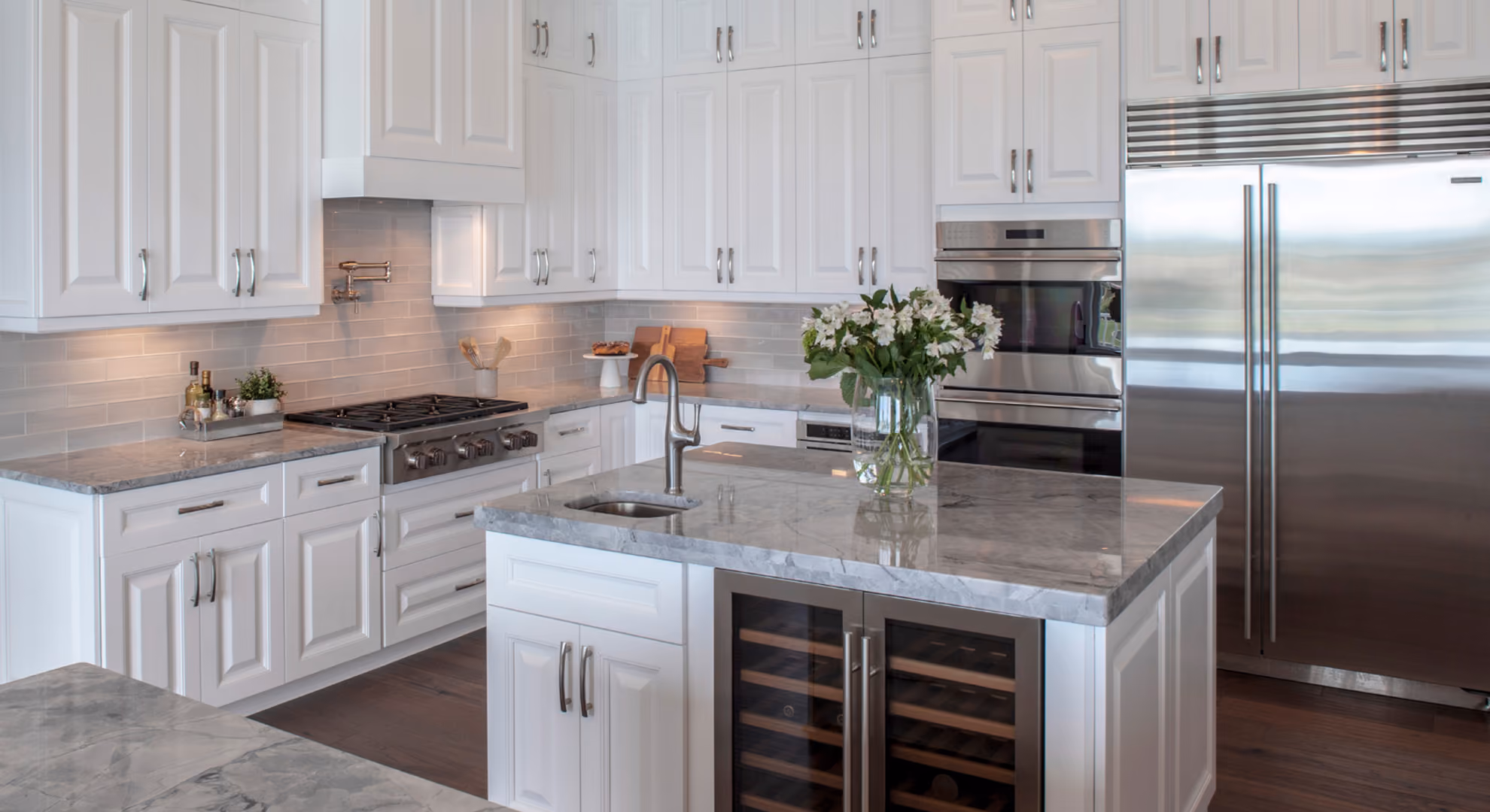 Kitchen: white raised-panel with stainless fridge and wine cooler
