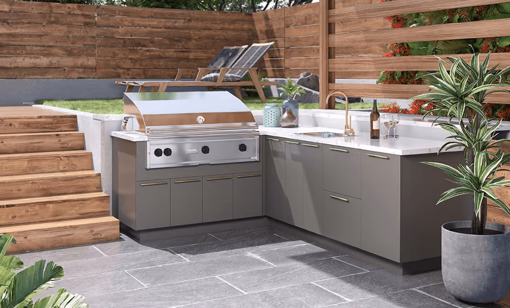 Charcoal Gray Endura outdoor kitchen beside garden steps and a wood fence