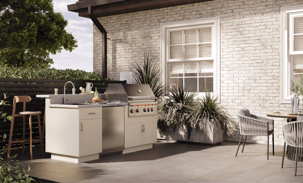 Cream Endura outdoor kitchen against a white brick wall