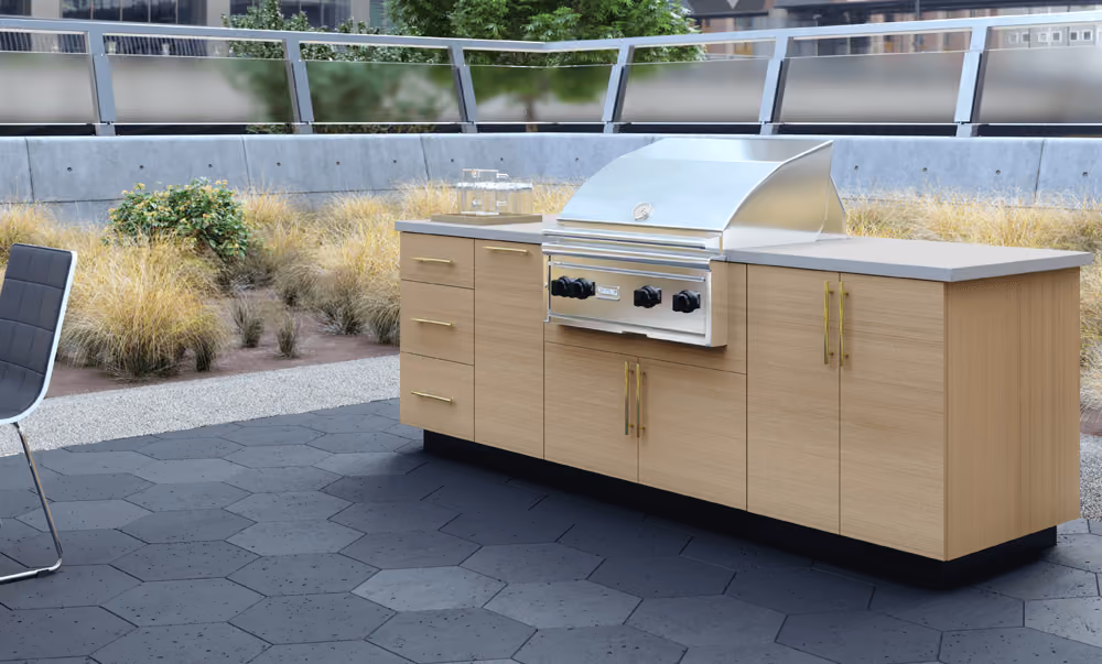 White Oak Endura outdoor kitchen with a grill on a stone patio