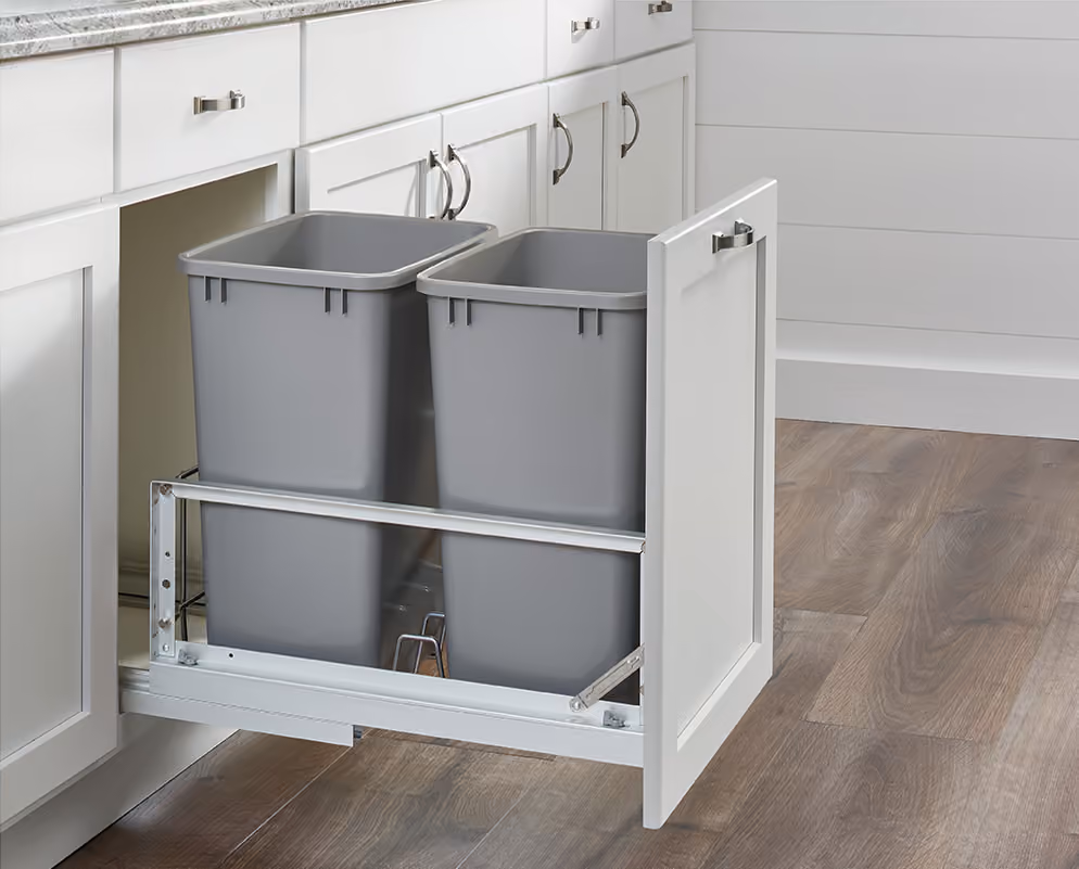 Double pull-out waste bins in a base cabinet