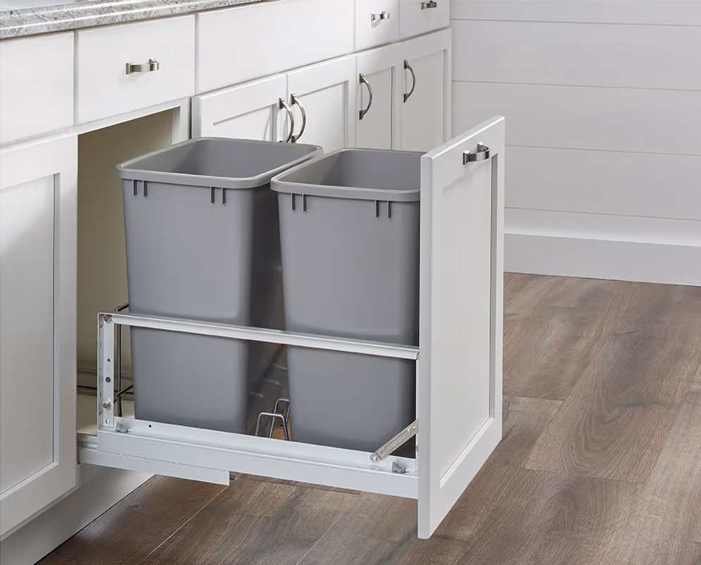 Double pull-out waste bins in a base cabinet