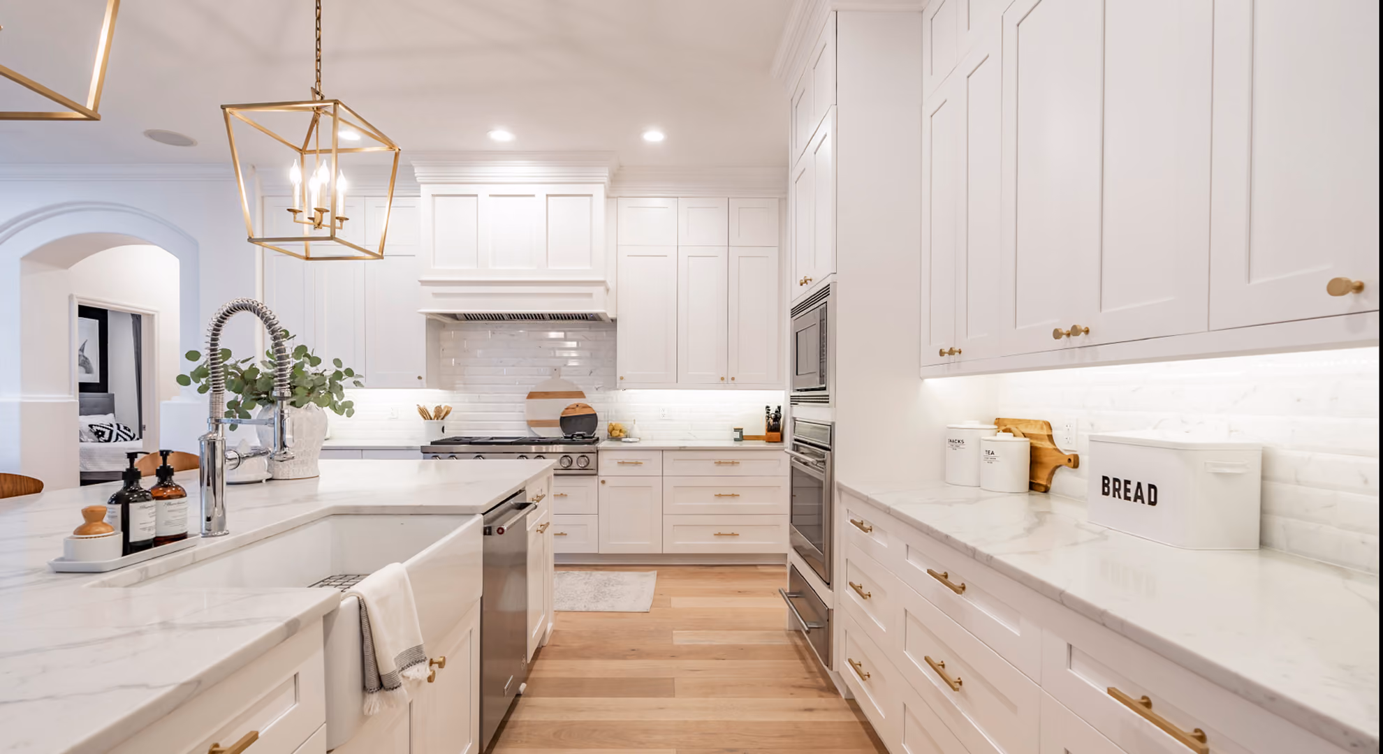 Kitchen: white shaker with brass pendants and farmhouse sink