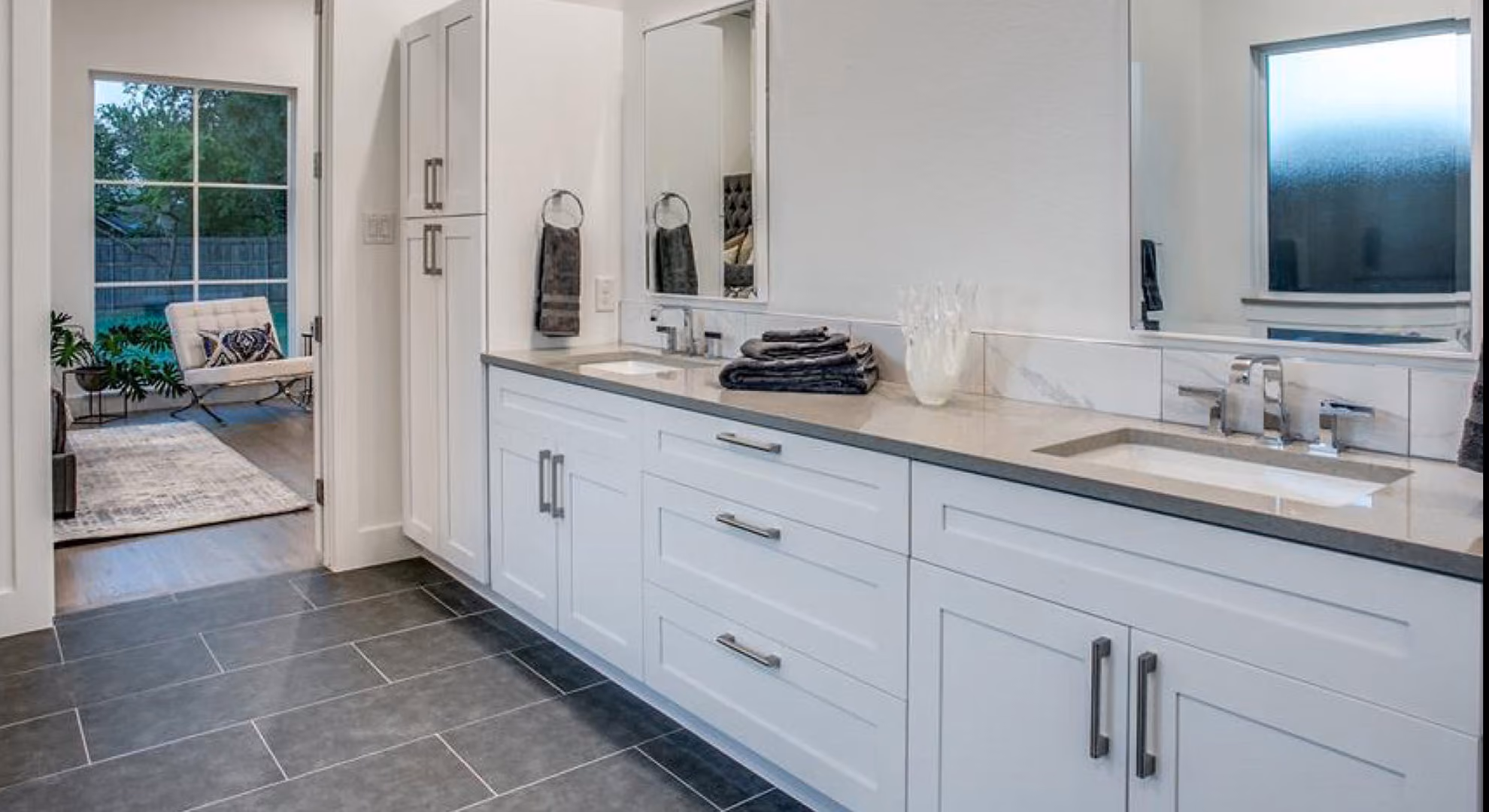 Bath vanity: white shaker, double sinks, slate floor