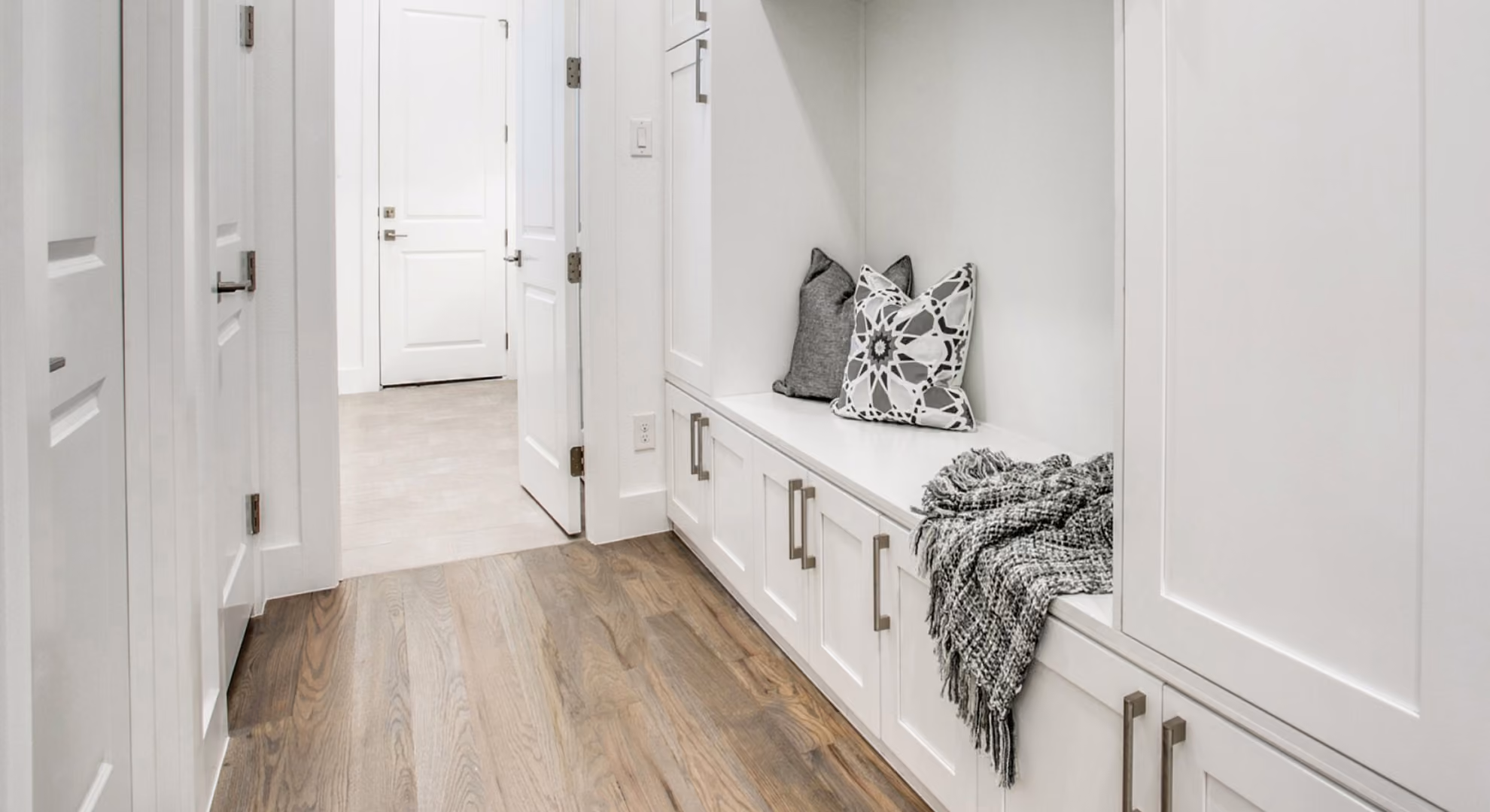 Entry mudroom bench with white cabinetry