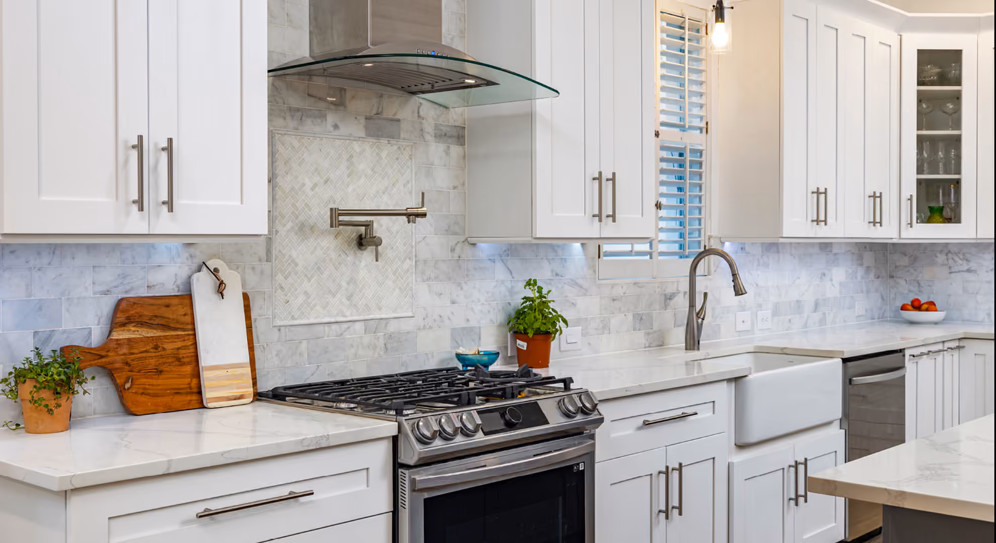 White shaker kitchen with a marble backsplash