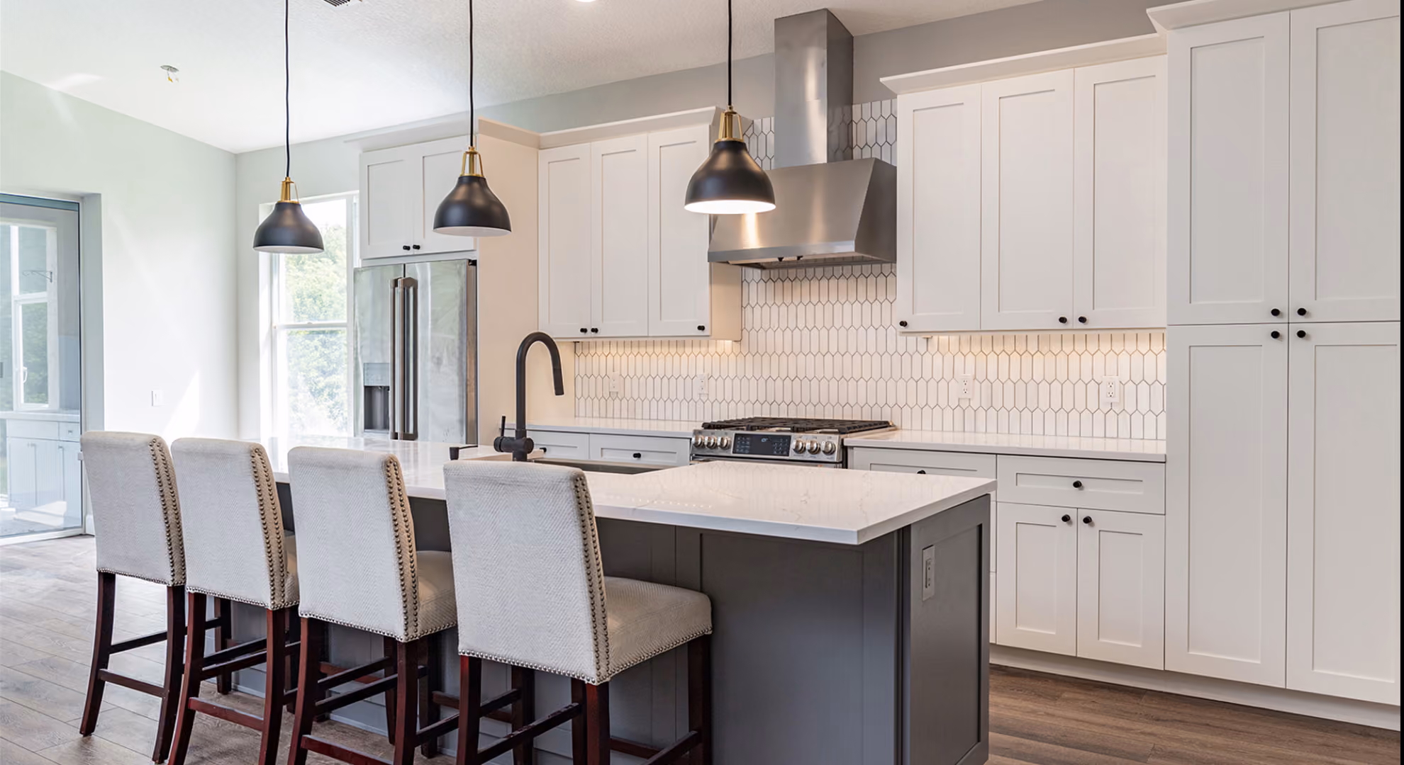 Kitchen: white shaker with navy island and stools