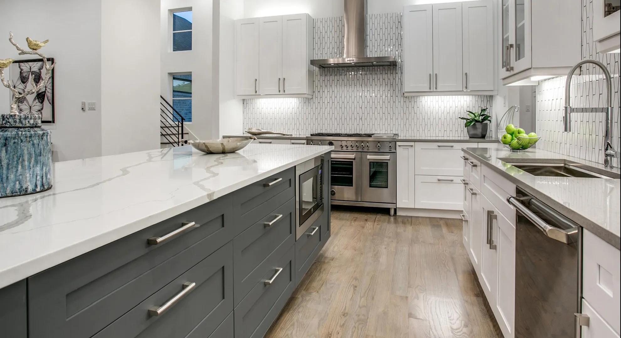 Gray shaker base cabinets with white uppers and double ovens