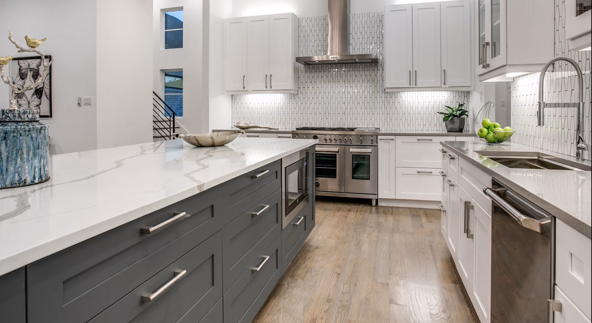 Kitchen: gray base cabinets with white uppers, double oven