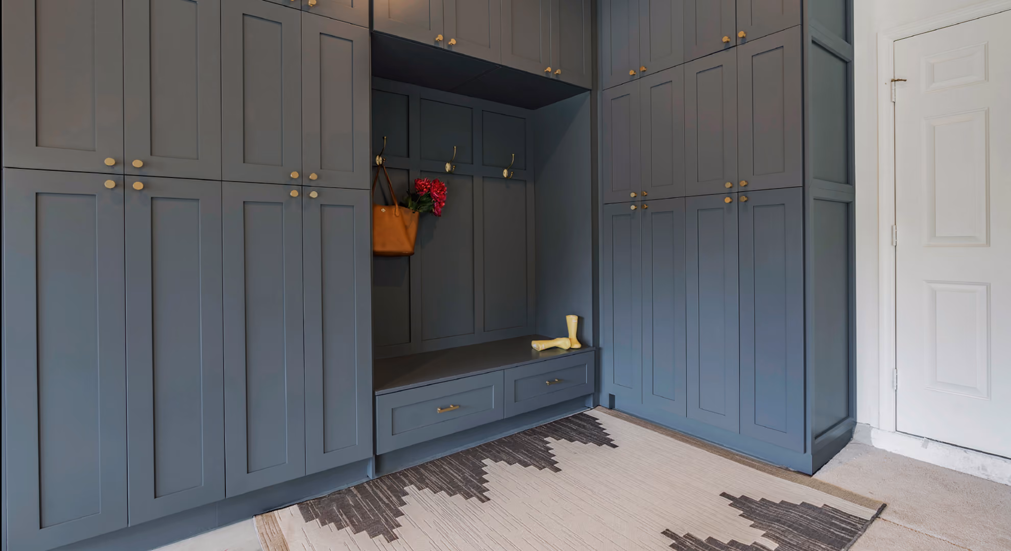 Mudroom: blue-gray (Storm Gray) cabinets with bench